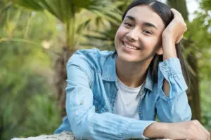 Woman smiling with a perfect smile and white teeth in a park and looking at the camera