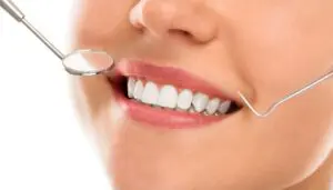 https://pixabay.com/photos/caries-checkup-clinic-clinical-10184704/ Smiling person with dental tools