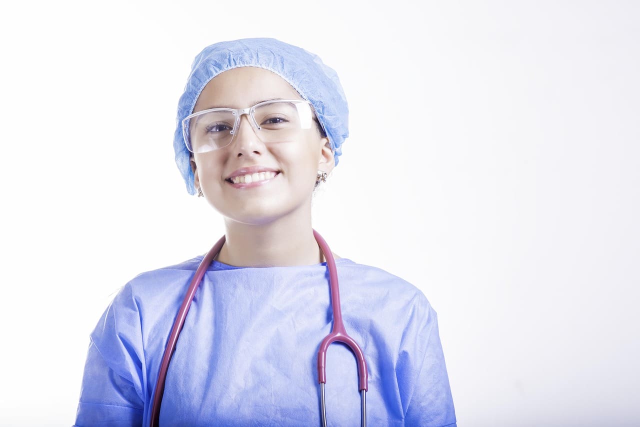 Surgical nurse preparing tools in a clinical setting before oral surgery